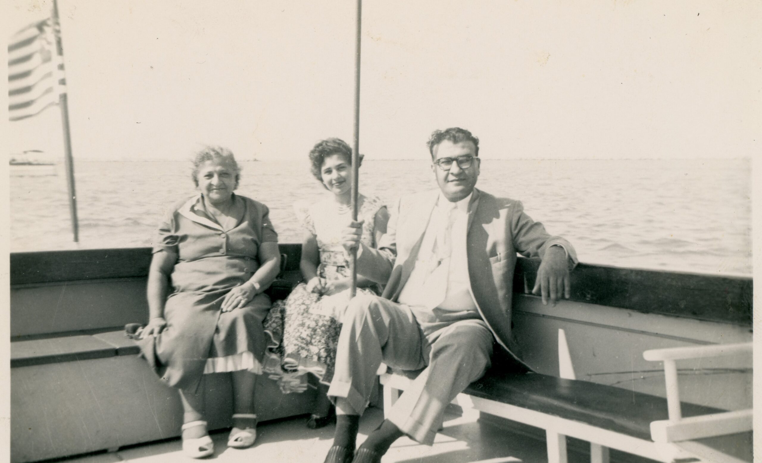 Three people sitting in a boat