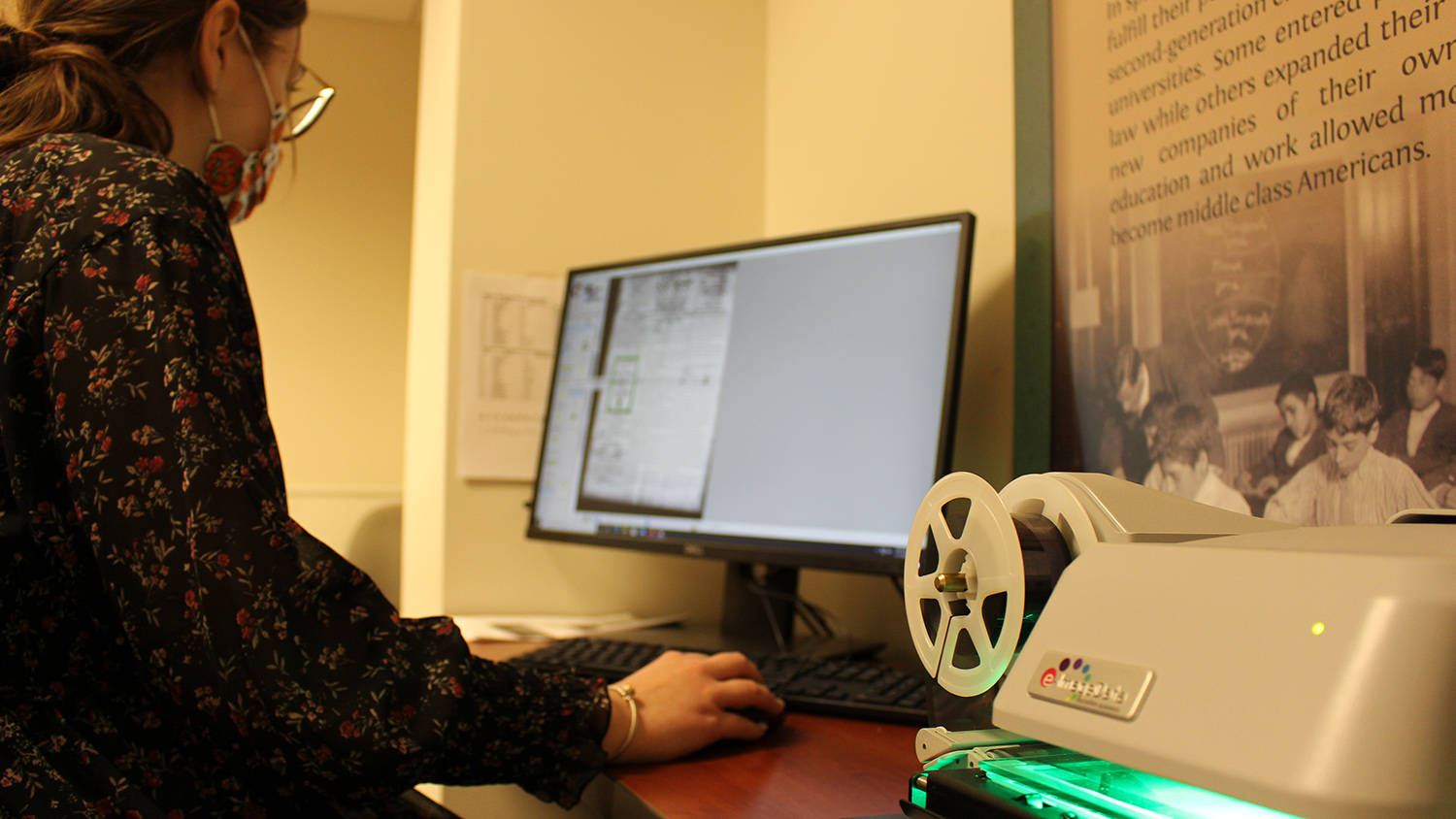 A Khayrallah Center staff member looks through an archive